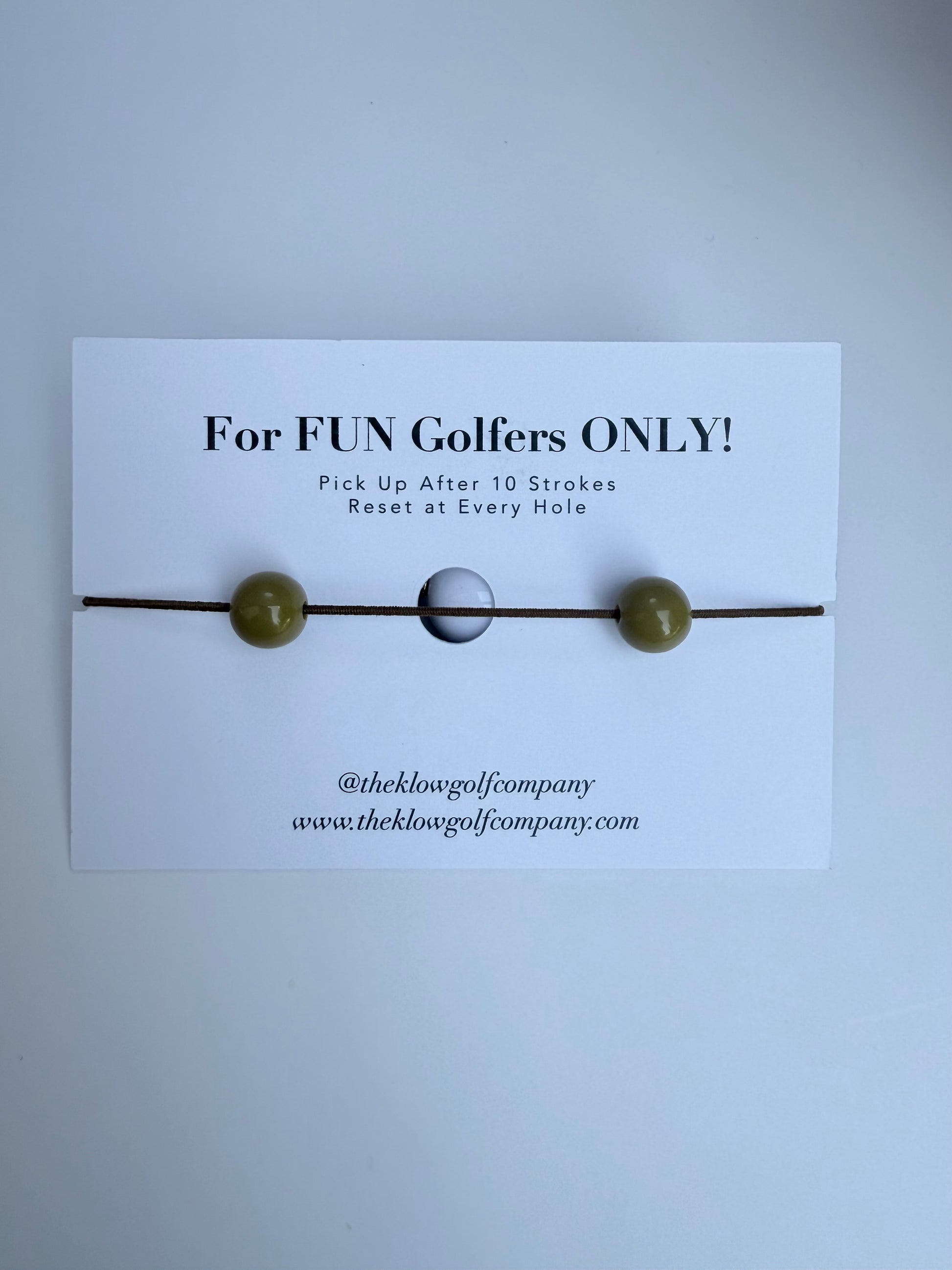 Golf Stroke Counter Bracelet with a card labeled 'For FUN Golfers ONLY!' on a light gray background