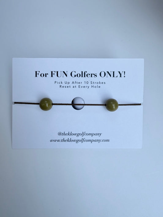 Golf Stroke Counter Bracelet with a card labeled 'For FUN Golfers ONLY!' on a light gray background