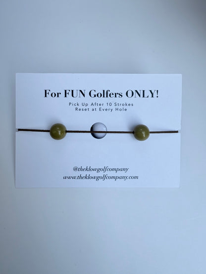 Golf Stroke Counter Bracelet with a card labeled 'For FUN Golfers ONLY!' on a light gray background