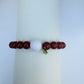 Bracelet with red and white beads on a white background
